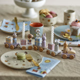 Junaid Cat Birthday Decoration wooden train with number 3 candle, mouse, rabbit and bear figures on parcel wagons, styled on a table with party tableware.