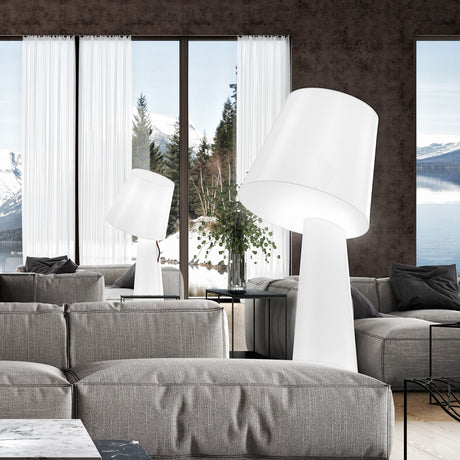Big Brother 3 Light Fabric Floor Lamp in white, shown in a living room with a tilted drum shade on a tall tapering base, both glowing white fabric.