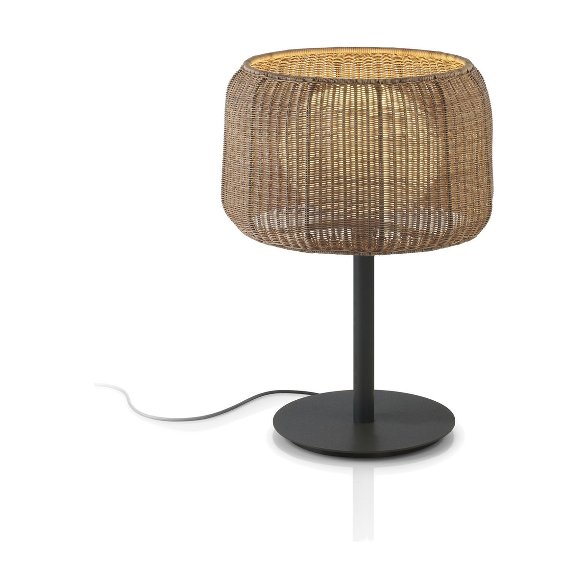 Fora M Rattan LED Outdoor Table Lamp with a woven Rattan Brown drum shade, round disc base, and dark stem, set against a plain white background.