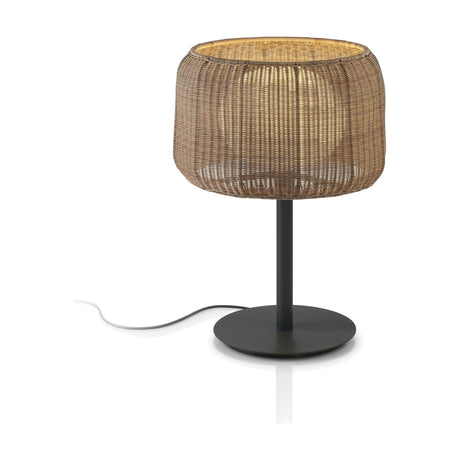 Fora M Rattan LED Outdoor Table Lamp with a woven Rattan Brown drum shade, round disc base, and dark stem, set against a plain white background.