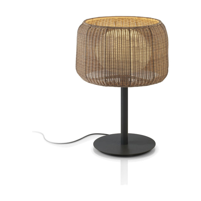 Fora M Rattan LED Outdoor Table Lamp with a woven Rattan Brown drum shade, round disc base, and dark stem, set against a plain white background.