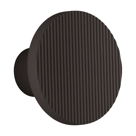 Arid A/01 round LED wall light in Textured Black aluminium, showing a fluted disc face on a short stem, set against a plain white background.