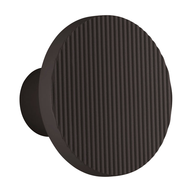 Arid A/01 round LED wall light in Textured Black aluminium, showing a fluted disc face on a short stem, set against a plain white background.