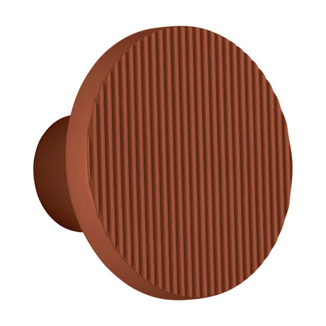 Arid A/01 round aluminium LED wall light in textured terracotta, a ribbed disc on a short cylindrical stem, shown against a plain white background.