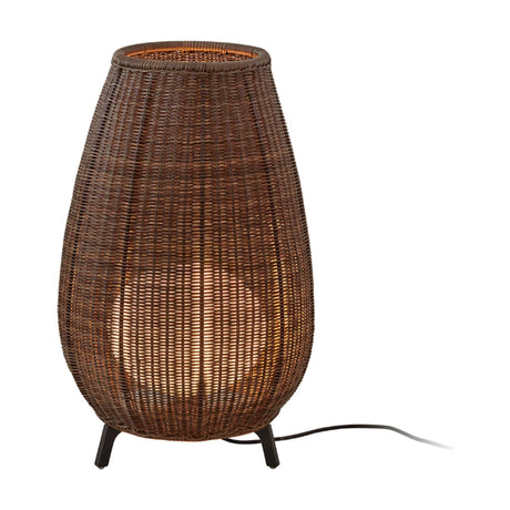 Amphora 01 outdoor floor lamp with tall rounded brown rattan-style woven shade, open top, warm glow, and three short dark legs, shown on a plain white background.