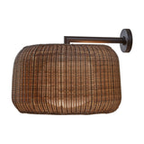 Fora A outdoor wall light with a wide, rounded Rattan Brown woven drum shade on a graphite brown wall arm and round wall plate, shown against a plain white background.