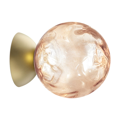Murané 15cm pink glass sphere wall and ceiling light with rippled champagne-toned glass on a brushed brass domed mount, shown against a plain white background.