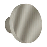 Arid A/01 round aluminium LED wall light with fine vertical fluted disc face in Textured Pebble Grey, shown on a cylindrical wall stem against a plain white background.