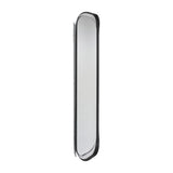 The narrow oval mirror turned to a steep angle, showing the black frame in profile and how far the curve stands off the wall.