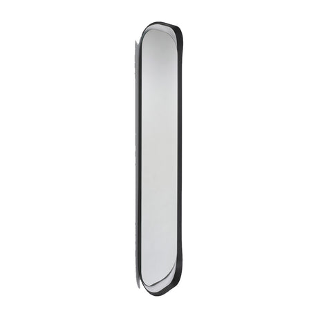 The narrow oval mirror turned to a steep angle, showing the black frame in profile and how far the curve stands off the wall.