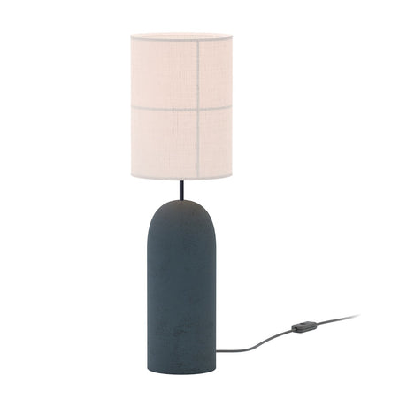 Rania table lamp with a cylindrical anthracite concrete base and white cream fabric shade featuring stitched grid lines, shown against a plain background with cable and switch.