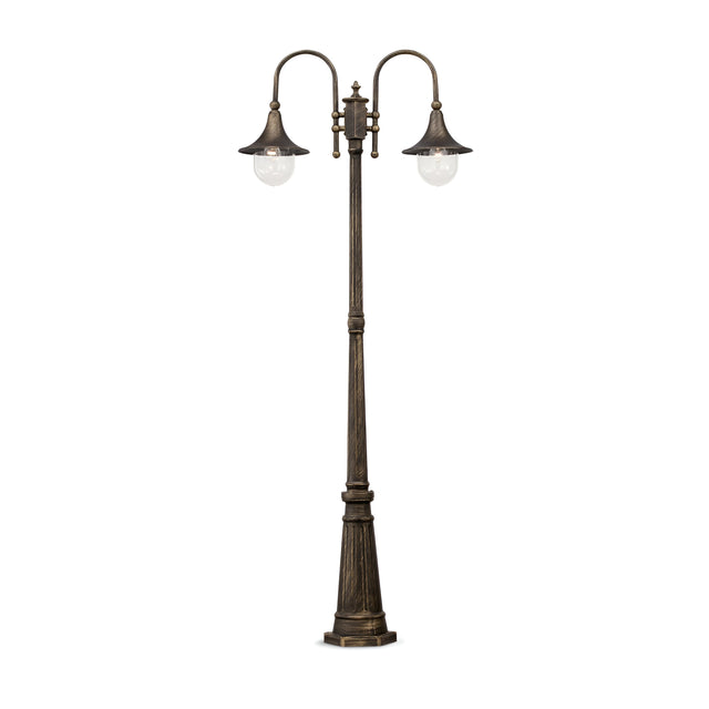 Presenting the Lumis Twin Head Lamp Post - Black, a vintage-style outdoor lighting option. Featuring two elegantly curved arms with glass bulbs and a bold black finish, it offers an antique charm against a minimalist white backdrop.