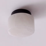Rock LED Alabaster Drum flush ceiling light with white alabaster shade on a black aluminium base, shown against a plain white background.