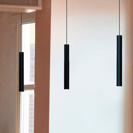 Rose Cylinder Pendant Light in matt black, slim cylinder shades on fine cables, shown in a room near a window and wall in varying lengths.