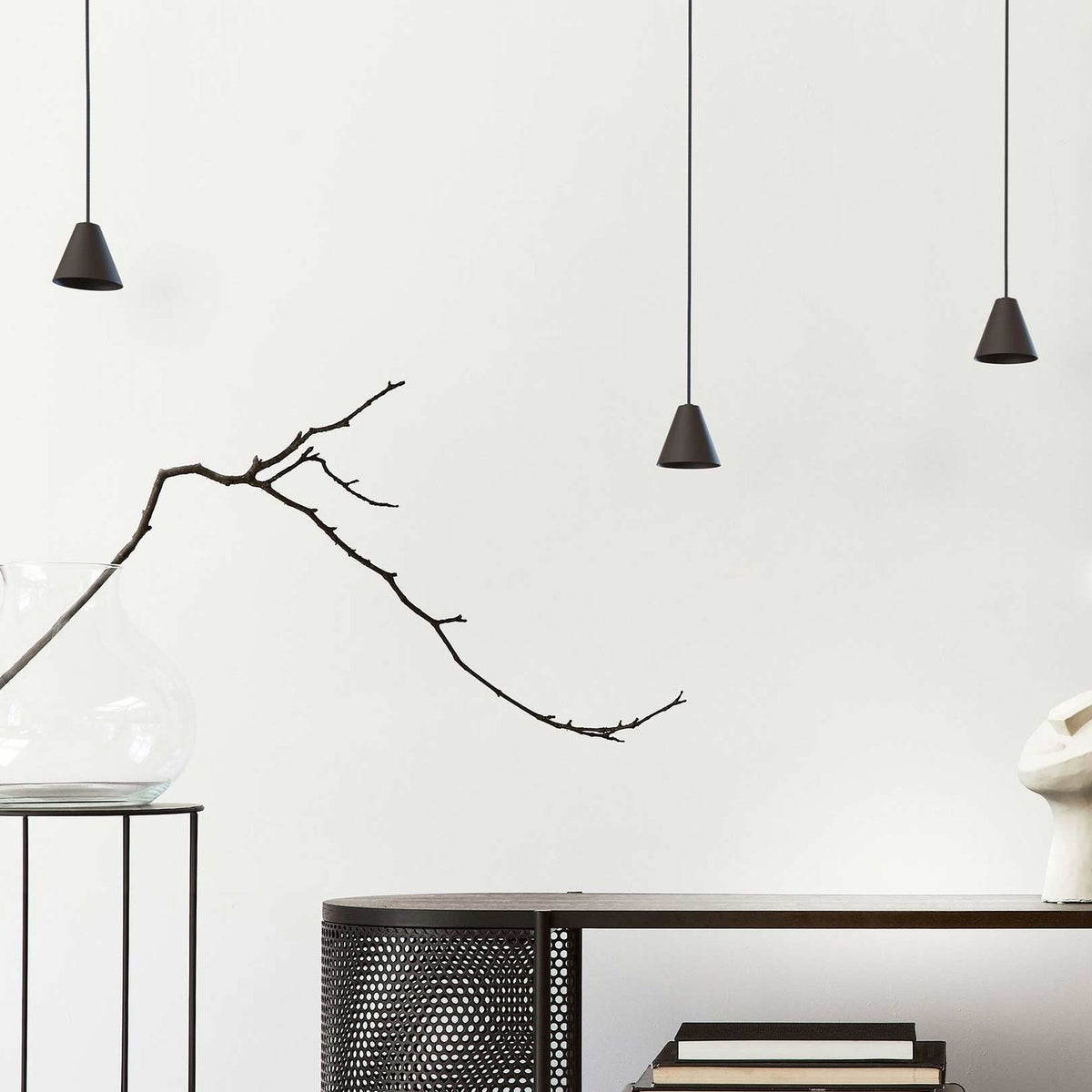 Rimini LED Cone pendant lights in matt black with conical iron shades on black textile cables, shown at varying drop heights in a neutral room setting.