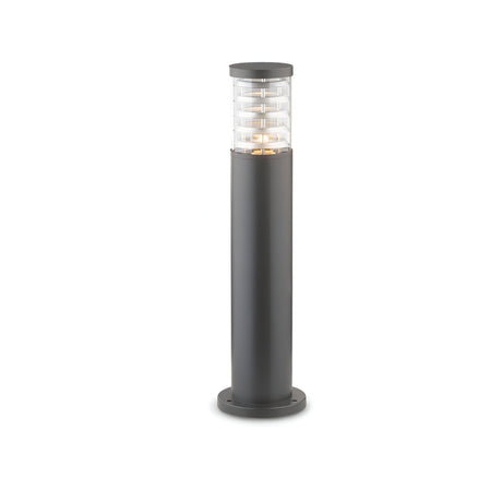 The Luminis Outdoor Bollard Light - Anthracite, 60cm features a sleek cylindrical design with durable die-cast aluminium construction and an anthracite paint finish. It has a black base and clear top adorned with horizontal ridges, offering diffused illumination for pathways, elegantly contrasted against a white background.