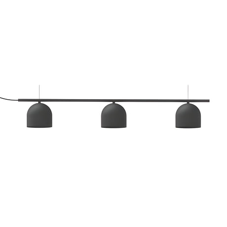 Rio Linear 3 Light Dome Chandelier in matt black iron, three dome shades suspended beneath a slim horizontal bar on fine wires, shown on a plain white background.