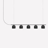 Rio Linear 5 Light Dome Chandelier in matt black, five small dome shades aligned beneath a slim iron bar with a curved textile cable, shown on a plain white background.