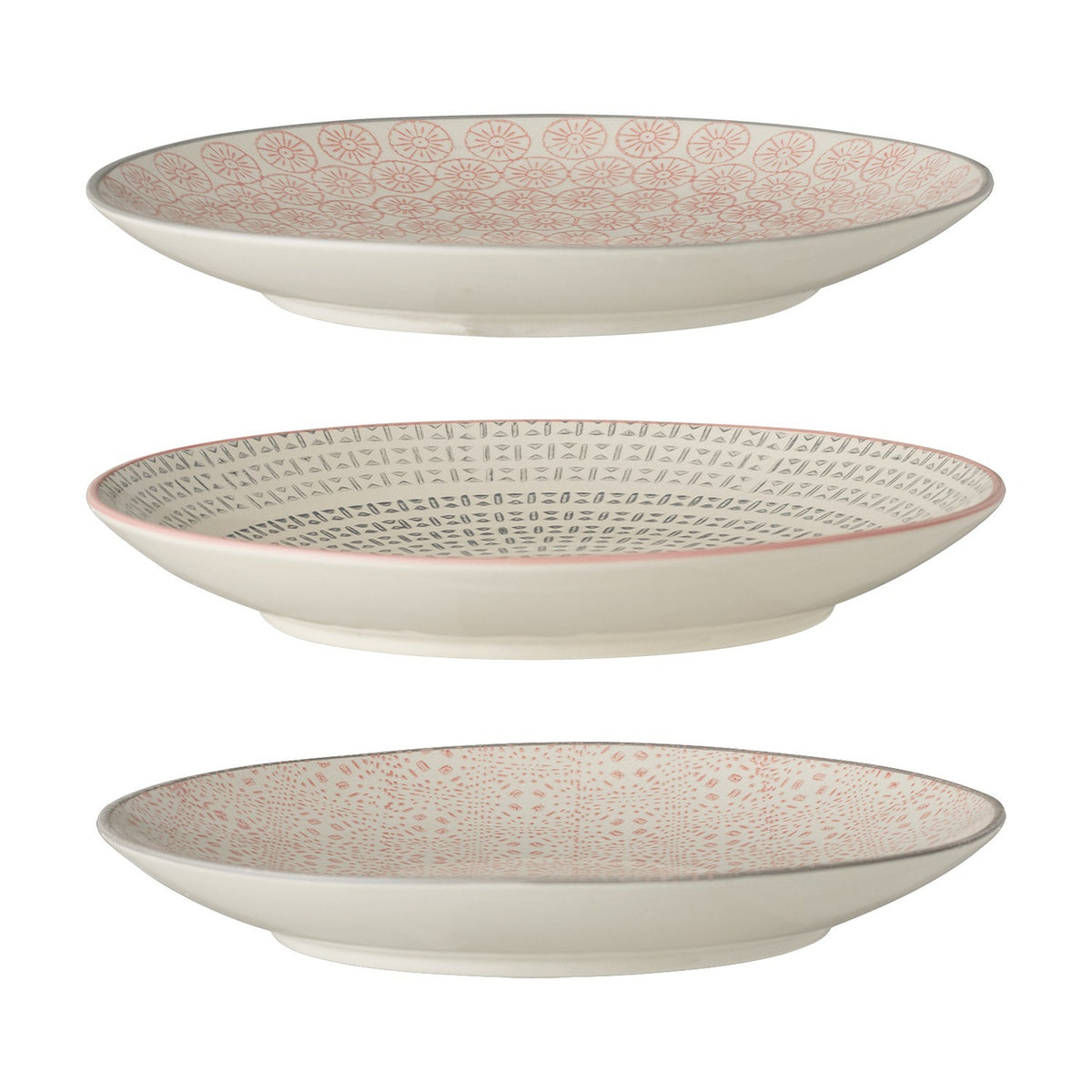 Cécile ceramic side plates in three assorted patterned designs, cream with pink and grey motifs, shown stacked on a plain white background.