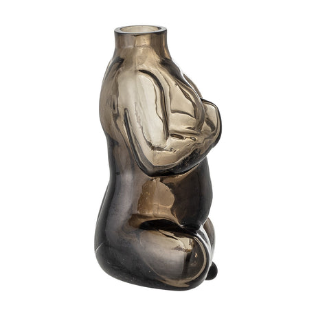Elze Glass Vase 12.5cm in Brown, a seated-figure shaped glass vase with crossed legs and hands at the chest, translucent brown finish darkest at the base, shown on a plain white background.