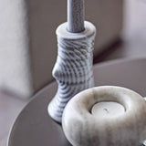 Raheem Stoneware Candle Holder 13cm in grey, taper-style with ridged, branch-like texture, shown beside a round tealight holder on a dark tabletop.