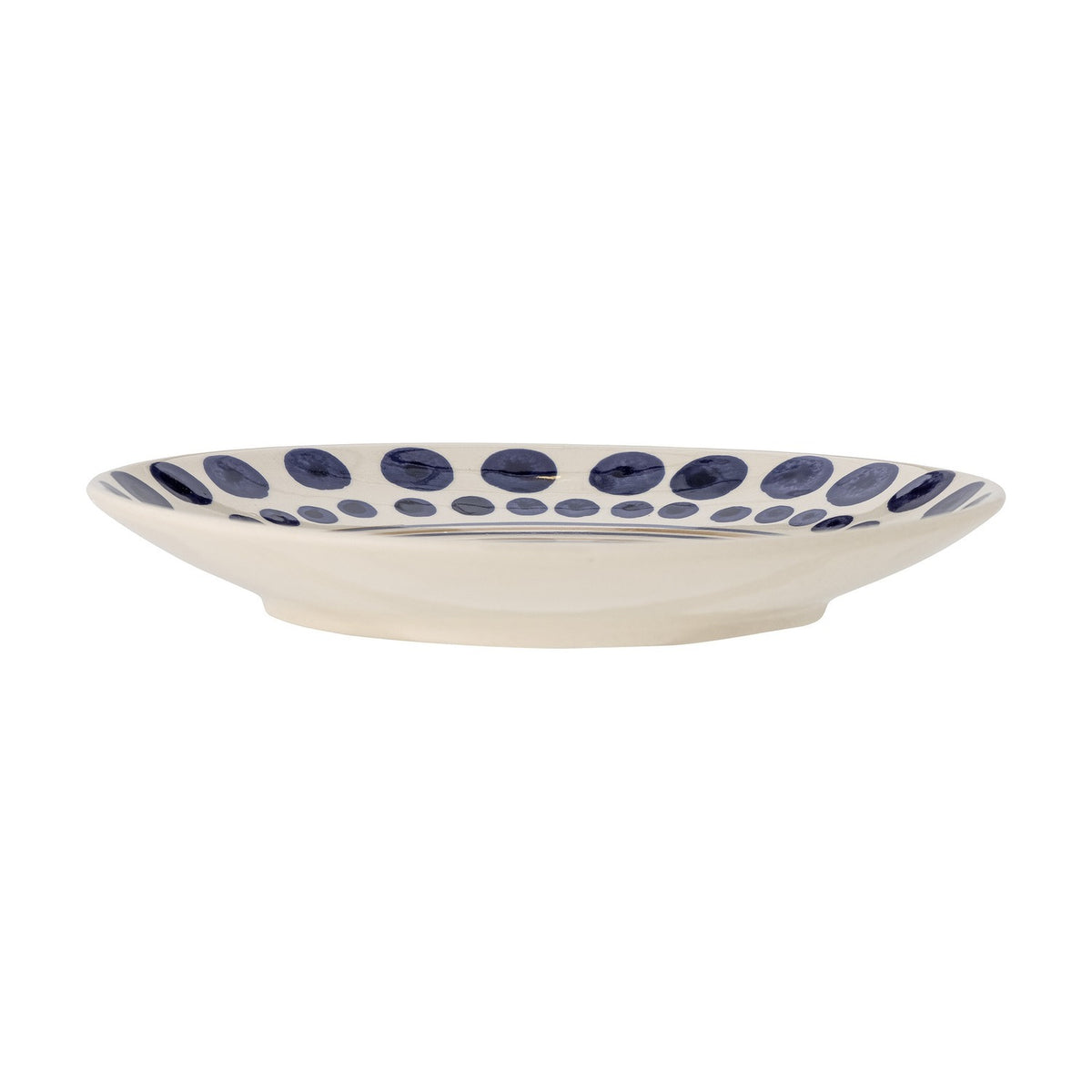 Side view of the Shama Dotted Stoneware Dinner Plate, a cream ceramic plate with a wide rim featuring a double ring of hand-painted blue dots, shown on a plain white background.
