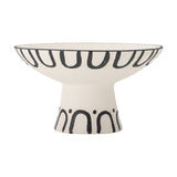 Mayotte Stoneware Pedestal Bowl 26cm in cream, with a flared footed base, black loop pattern beneath the rim, and arch-and-dot design around the foot, shown on a plain white background.