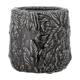 Nikou Terracotta Plant Pot in black, a round planter with raised botanical leaf and frond relief covering the glossy textured surface, shown on a plain white background.