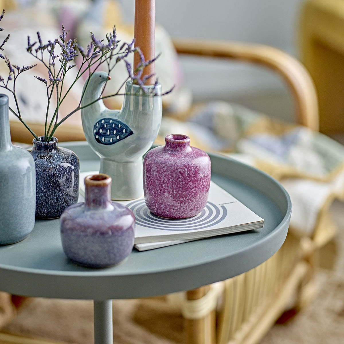 Maien Speckled Stoneware Vases 14cm Set of 7 in multi glaze, shown as small bottle and rounded vases with dried flowers on a side table in a living room setting.