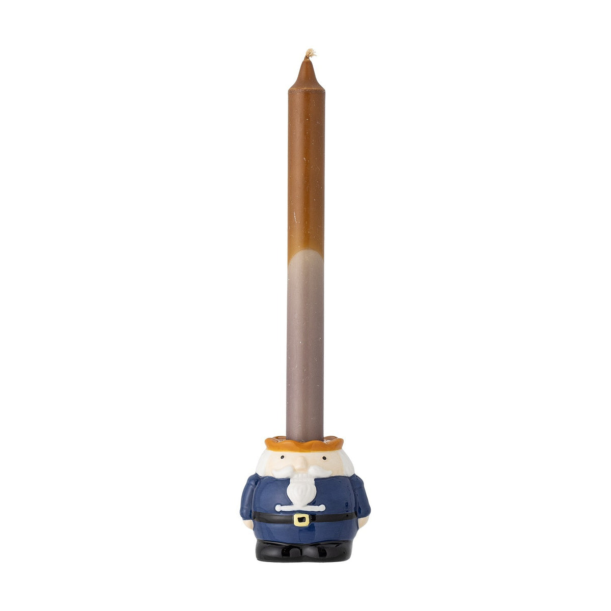 Feast Nutcracker stoneware Christmas candle holder in navy, white and orange, modelled with a bearded face and belted coat, holding a tall brown taper candle against a plain white background.