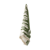 Haxby Throw in Green hanging against a plain white background, showing a bold irregular striped pattern in green and cream fabric with fringed edges.