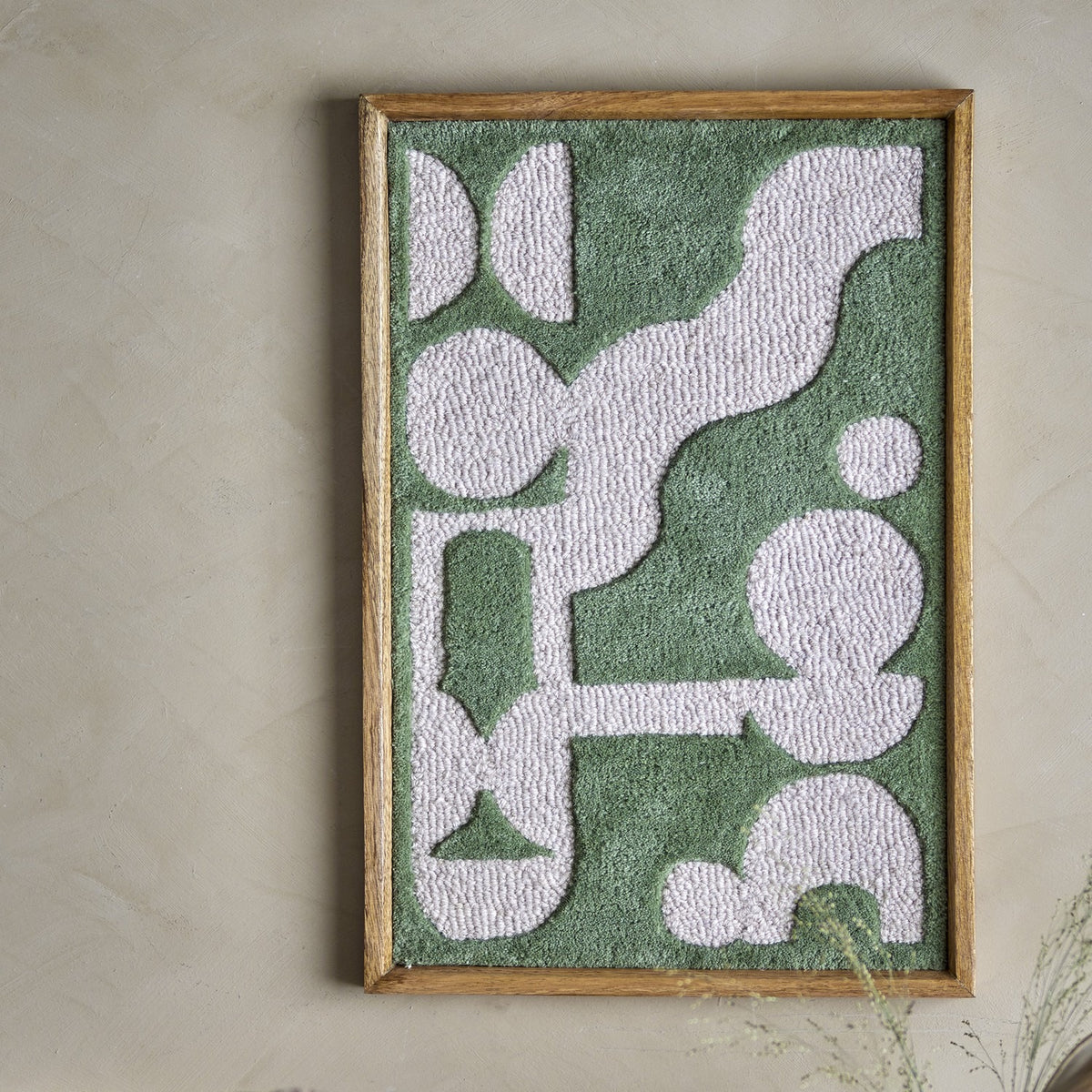 Longton Wool Wall Decor in green, a tufted abstract textile wall art in a slim wooden frame, mounted on a plain neutral wall.