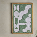 Longton Wool Wall Decor in green, a tufted abstract textile wall art in a slim wooden frame, mounted on a plain neutral wall.