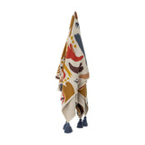 Horus Cotton Throw in Multi, a woven cotton-blend throw with a bold multicoloured abstract pattern, finished with navy tassels and shown hanging against a plain white background.