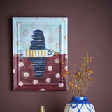 Brett birdy Wooden Framed Print in multicoloured, showing a bird in flight with scalloped wings, rings and dots, in a moulded wood frame on a dark wall above a vase.