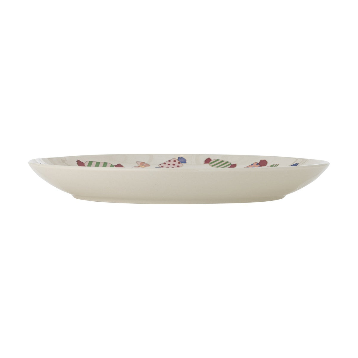 Side view of the Caramella stoneware Christmas dinner plate in cream, showing its shallow rim and multicoloured wrapped-sweet pattern along the edge, set against a white background.
