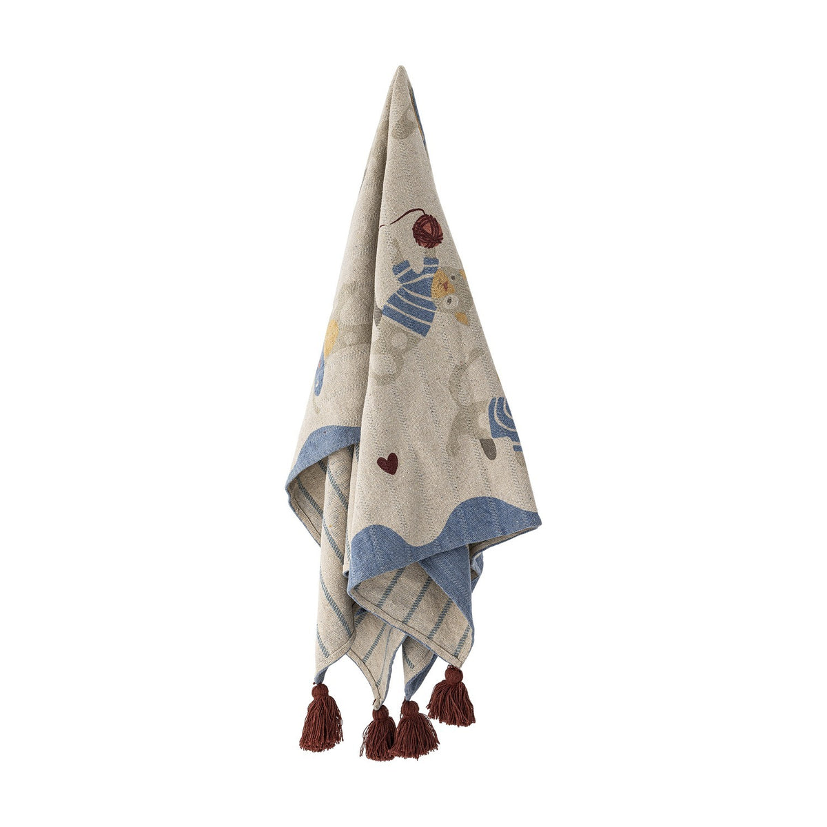 Mille Cotton Throw in beige, woven cotton blanket with cat and yarn ball print, wavy blue border, striped reverse, and corner tassels, shown hanging against a white background.