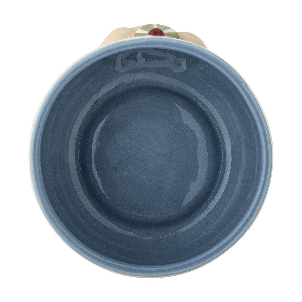 Top-down view of a stoneware kids' cup from the Party Dotted Dinner Set, showing a blue glazed interior and raised dog face detail on the outer rim, plain white background.