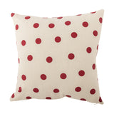 Bowie Dotted Cotton Christmas Cushion in cream, square shape with an allover red polka dot print on a textured cotton cover, shown against a plain white background.