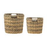Indra Striped Water Hyacinth Baskets Set of 2 in natural, woven storage baskets with cut-out handles and twisted rope rim edges, shown on a plain white background.