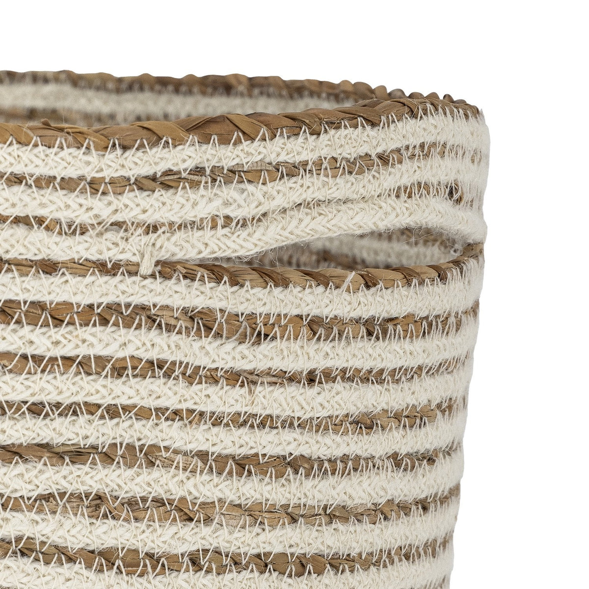 Close-up of the Selena Jute Basket in White with alternating bands of jute cord and braided seagrass, zigzag stitching, a braided rim, and a cut-out handle.