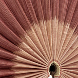 Close-up of the Jaime Bamboo Wall Decor in pink, showing pleated bamboo ribs radiating from a central woven hub with a hanging tassel.