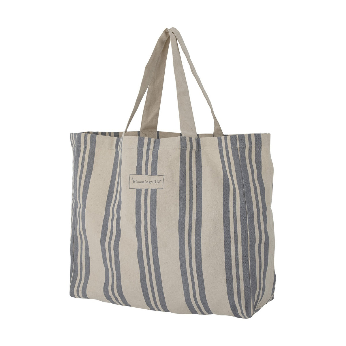 Trina Striped Cotton Shopping Bag in blue, a roomy canvas tote with vertical stripes of varying widths, two carry handles, and a small brand label, shown against a plain white background.
