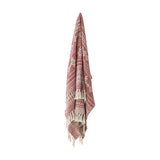 Oia Snowflake Cotton Christmas Throw in red, woven with striped and snowflake patterns and knotted tassel fringe, shown hanging against a plain white background.