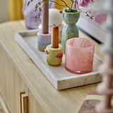 Majsa Marble Tray 38x18cm in white holding candlesticks and a vase on a wooden sideboard, showcasing its veined stone finish and raised rim.