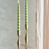 Ponza LED taper candles, pack of 2, green spiral-twist paraffin wax design on brass candlesticks against a neutral background.