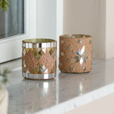 Miya round glass tealight holders, set of 2 in nude, one with mosaic diamond tiles, the other with a star motif, on a marble windowsill.