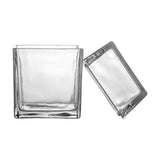 Elius clear glass storage jar with square body and pitched roof-shaped lid shown separately, set against a plain white background.