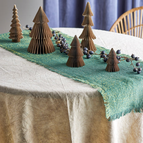 Milan Paper Christmas Decorations Set of 5 in brown, five tiered paper trees of varying heights displayed on a teal table runner with dark berries, styled on a dining table.