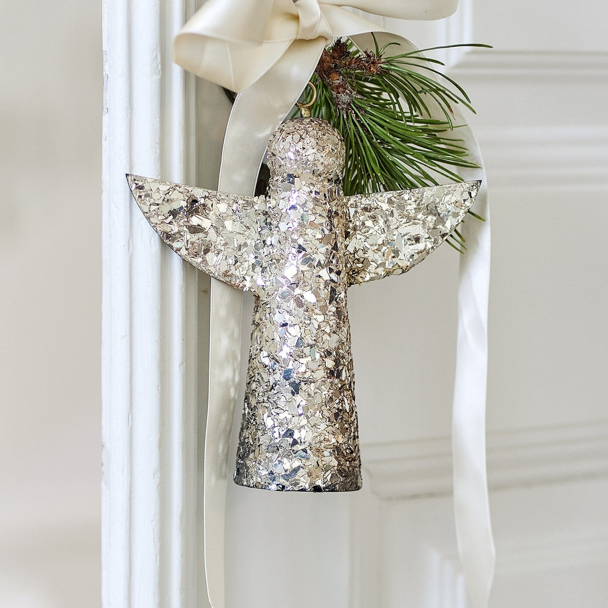Gold Sarika Iron Christmas angel ornament, 17cm, with mosaic glass detailing, hung from a cream ribbon with a pine sprig.